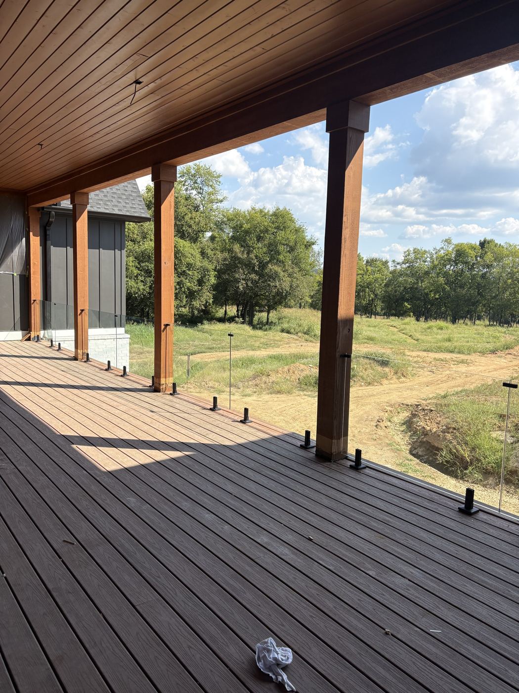 Glass railing panels on standoff posts over a deck