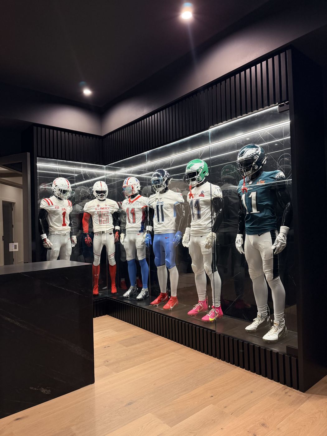Lighted L-shaped glass display case for a jersey collection