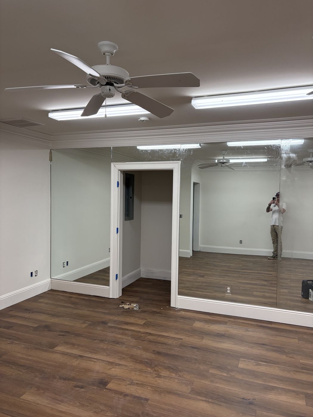 Full wall of floor-to-ceiling mirrors in a fitness room